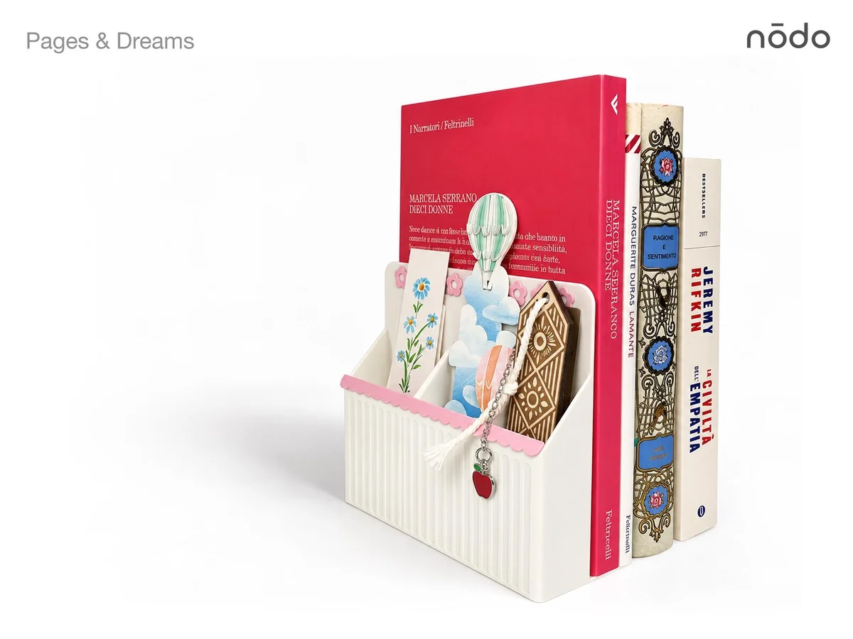 Nōdo Pages & Dreams cream and pink bookend holding books and decorative bookmarks.