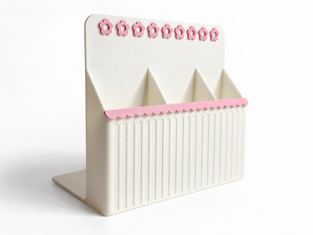 The empty Pages & Dreams bookend, showing three ribbed compartments and pink floral details.